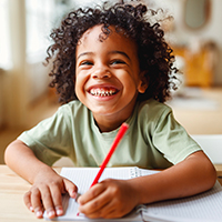 Boy smiles by showing his teeth